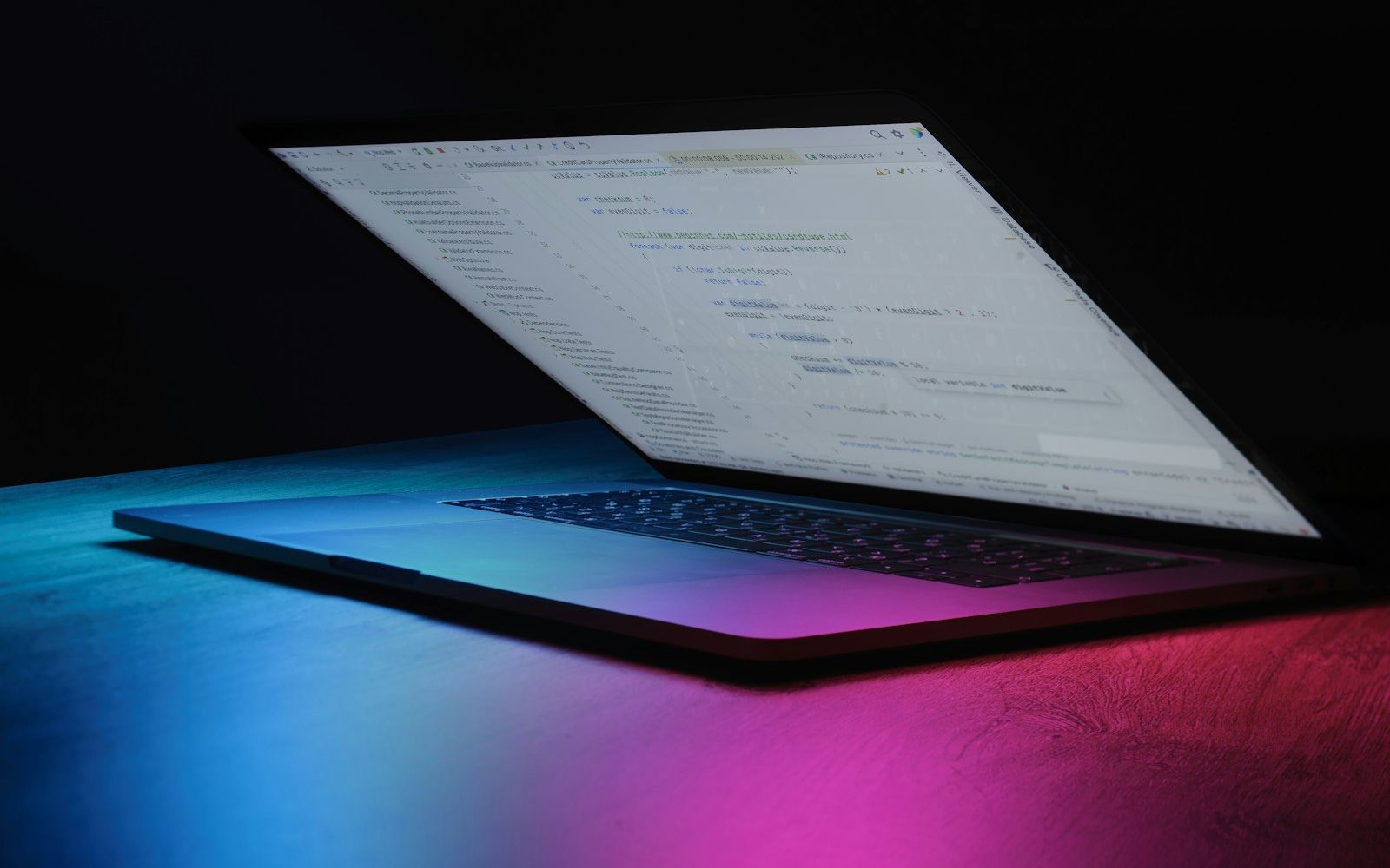 Open laptop in neon light